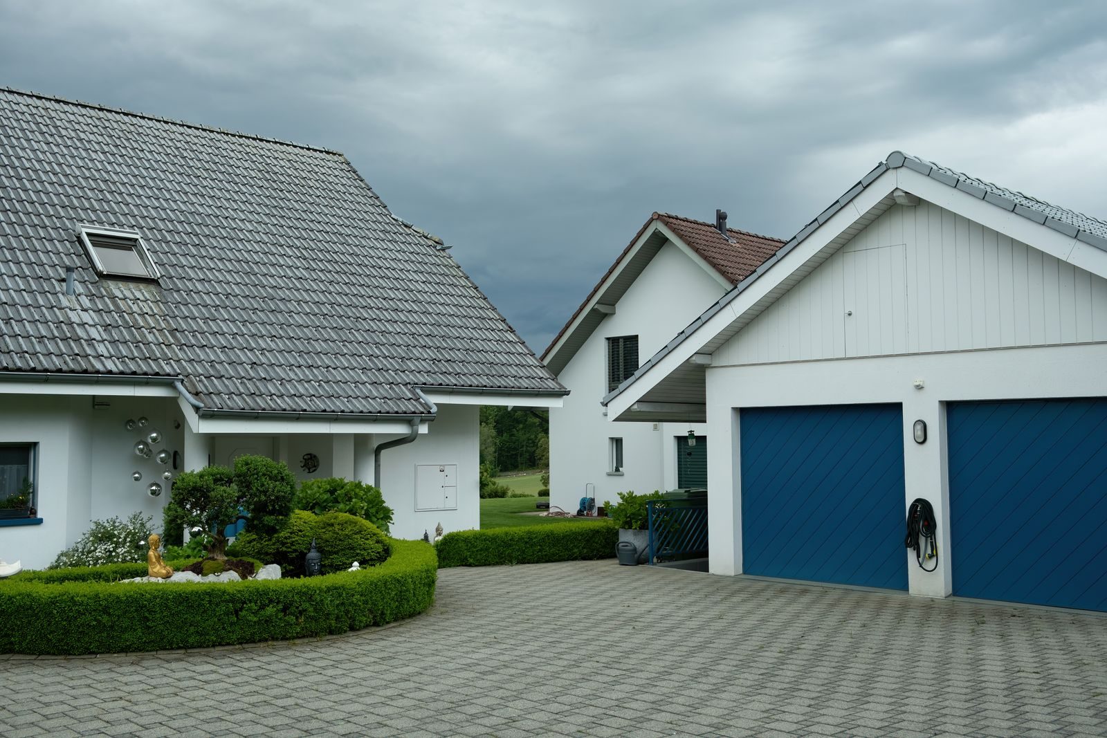 Interlocking paver driveway in front of a residential home