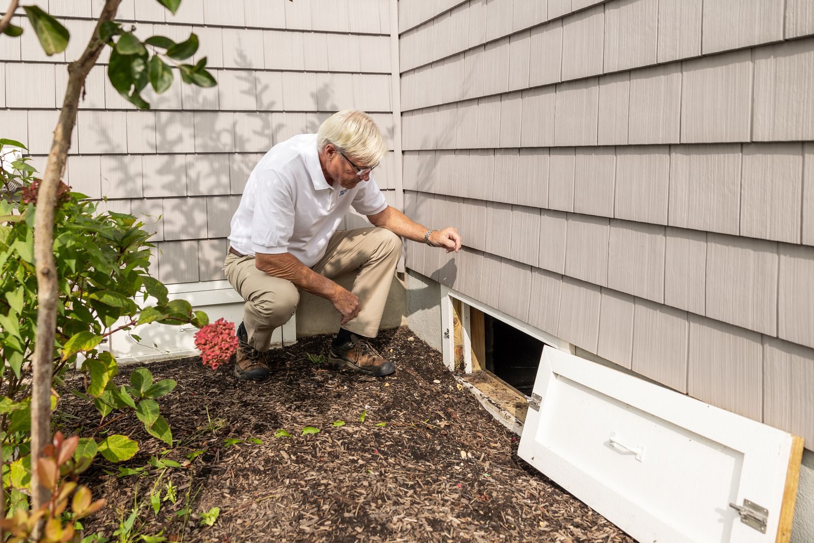 Tradesperson carrying out exterior renovation work on a house