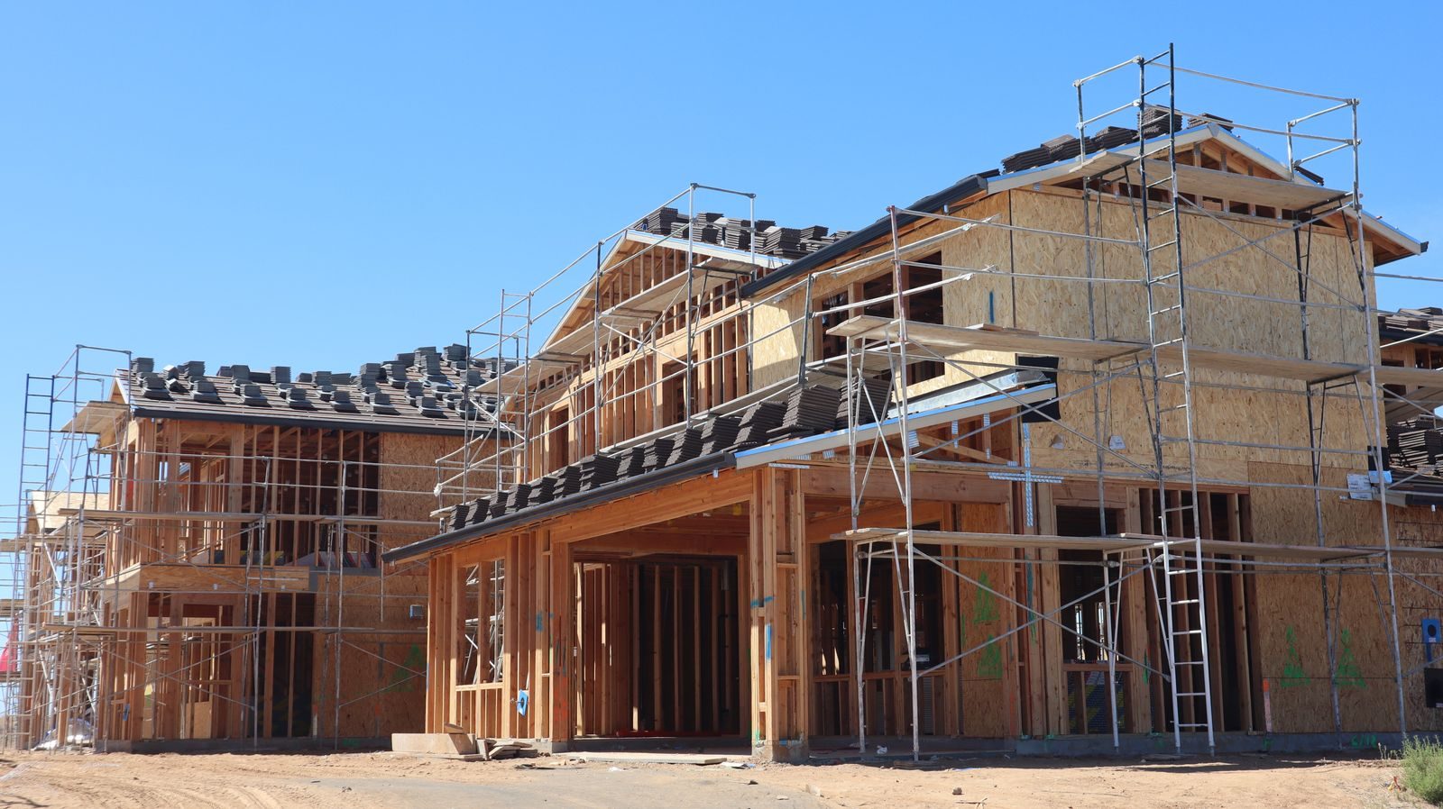 Timber framed house under construction with scaffolding